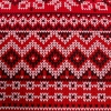 Zbliżenie tkaniny satynowej z motywem zygzaków i geometrycznych ściegów swetra norweskiego