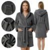 Kobieta prezentująca przód i tył ciepłego ciemnoszarego szlafroka z kapturem i kieszeniami na białym tle