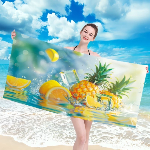 Uśmiechnięta kobieta w bikini trzymająca rozłożony duży ręcznik plażowy z mikrofibry w soczysty wzór ananasa i cytryn na