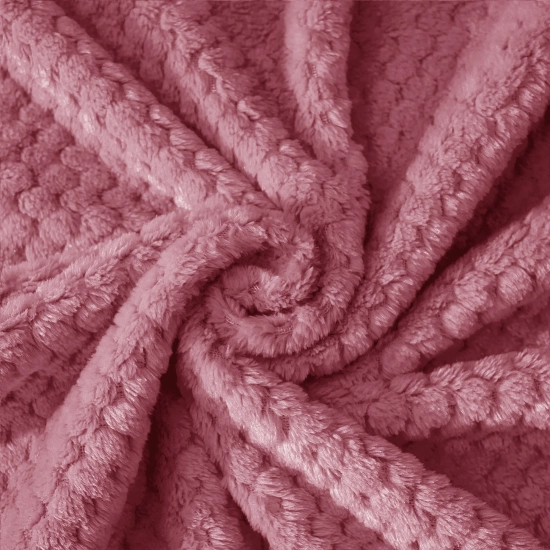 Tekstura miękkiej mikrofibry szlafroka w kolorze pudrowego różu ułożona w przestrzenną falę ukazująca gęstość materiału