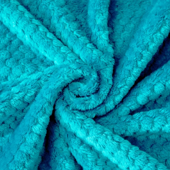 Tekstura miękkiej mikrofibry w kolorze turkusowym ułożona w przestrzenną falę ukazująca gęstość materiału
