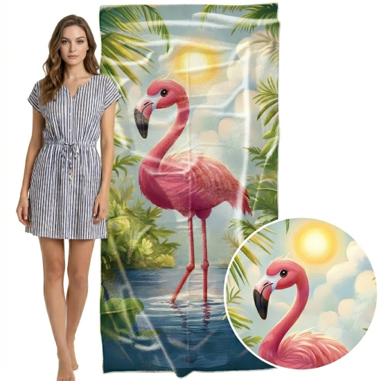 Kobieta w sukience obok pionowo zawieszonego ręcznika z mikrofibry w flaminga, zbliżenie na głowę ptaka i detale tropikalnego tła.
