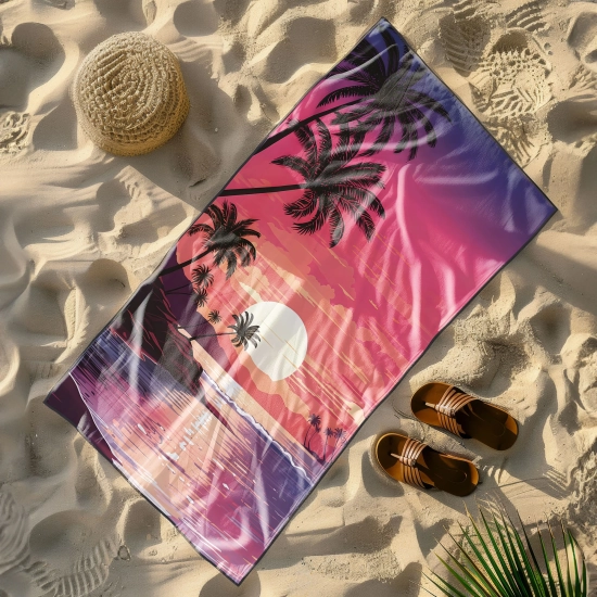 Wielki ręcznik plażowy Serena z neonowym zachodem słońca i czarnymi palmami, leżący na plaży obok słomkowego kapelusza