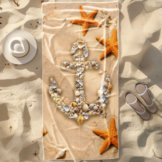 Duży ręcznik plażowy XXL z mikrofibry w stylu marynistycznym z kotwicą z muszli, rozłożony na piasku obok białego kapelu