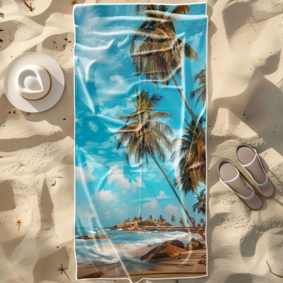 Duży ręcznik plażowy XXL z mikrofibry ze wzorem tropikalnej plaży z palmami, rozłożony na piasku obok kapelusza - TwójDo