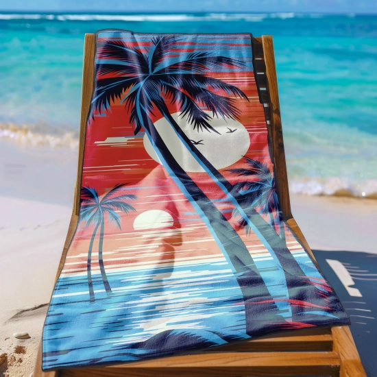 Ręcznik na wakacje z mikrofibry we wzór tropikalnego zachodu rozłożony na drewnianym leżaku na tle rajskiej plaży