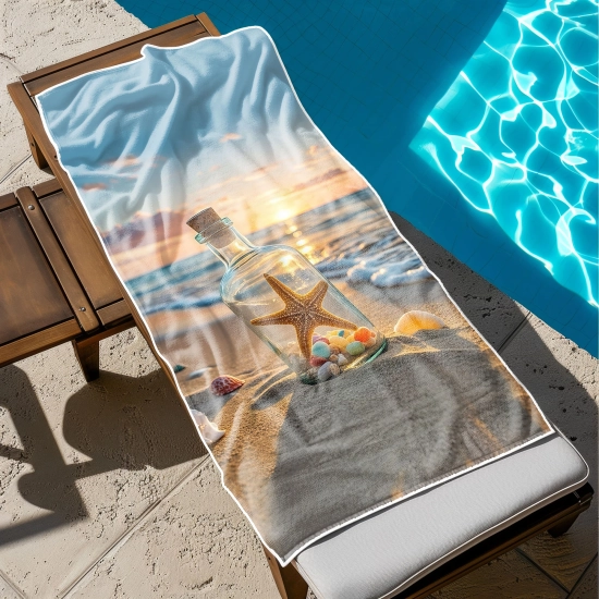 Ogromny ręcznik plażowy XXL z nastrojowym nadrukiem rozłożony w całości na drewnianym leżaku przy basenie